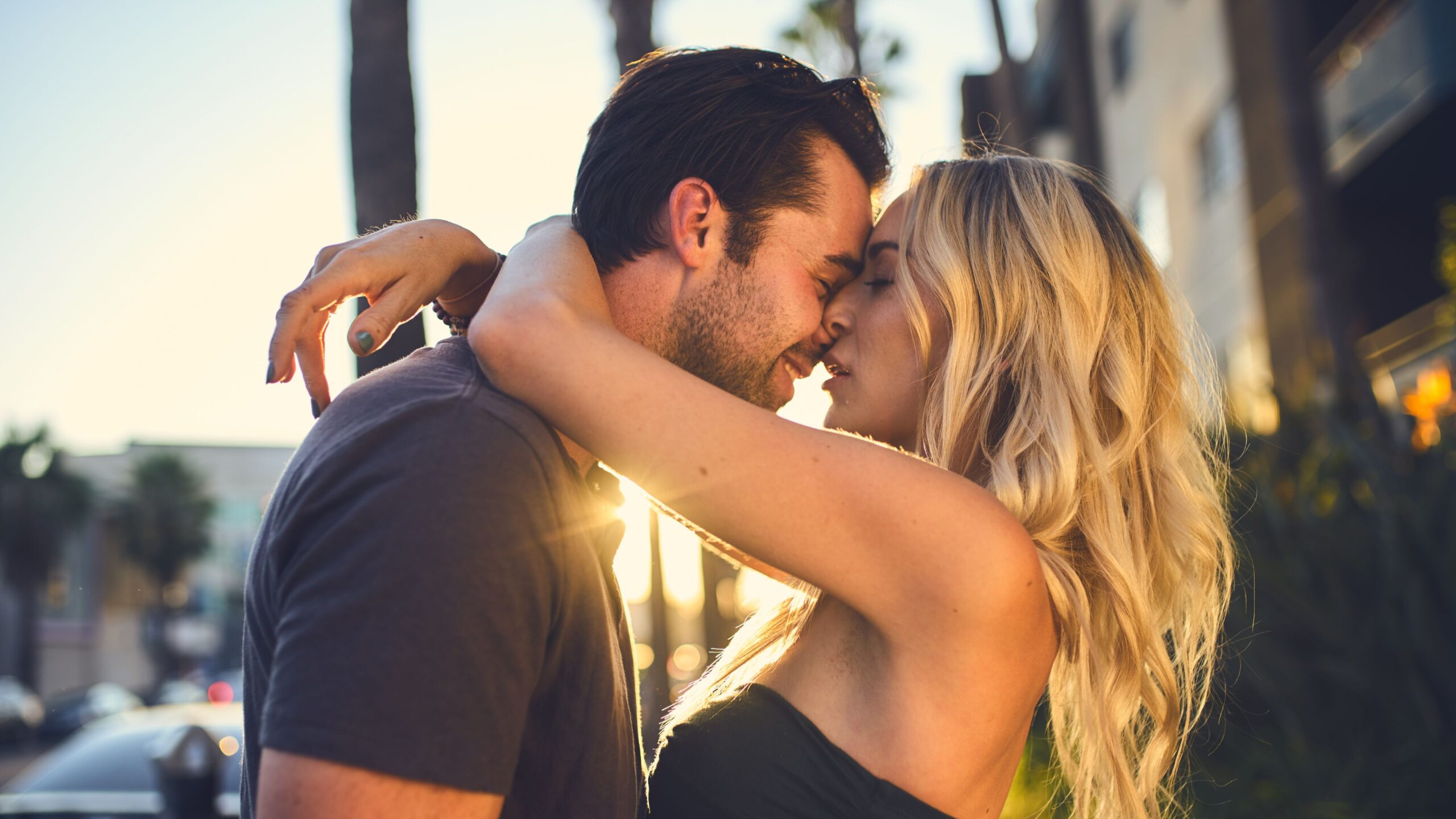 Power couple embracing in love at sunset.